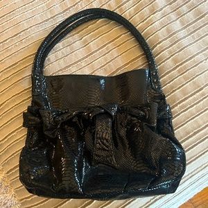Perlina black leather snake skin embossed shoulder bag with bow.